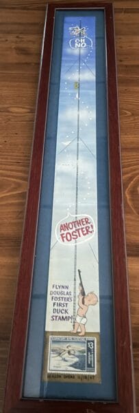 Framed display of a long vertical poster labeled 